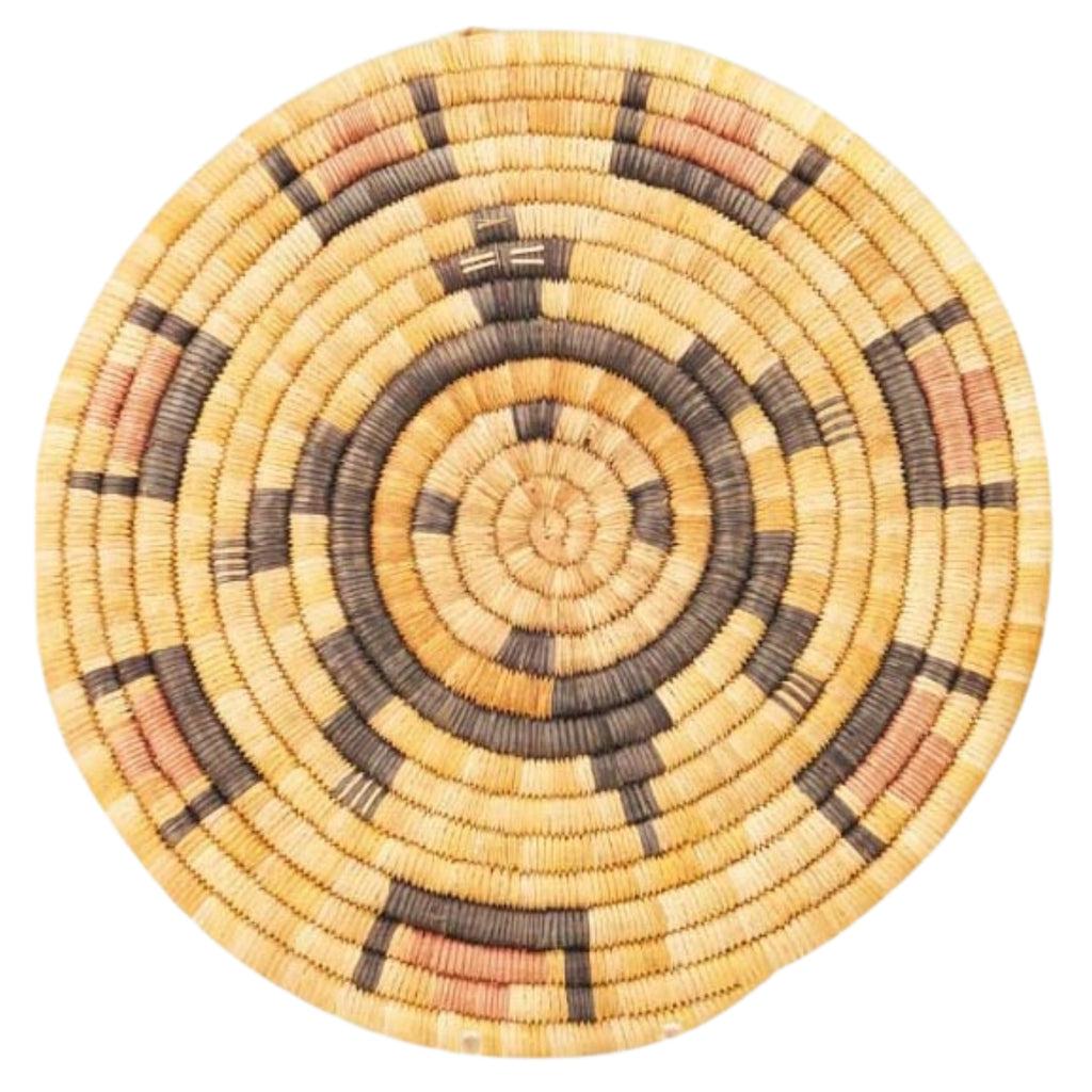 Round woven basket with concentric circle pattern on a white background