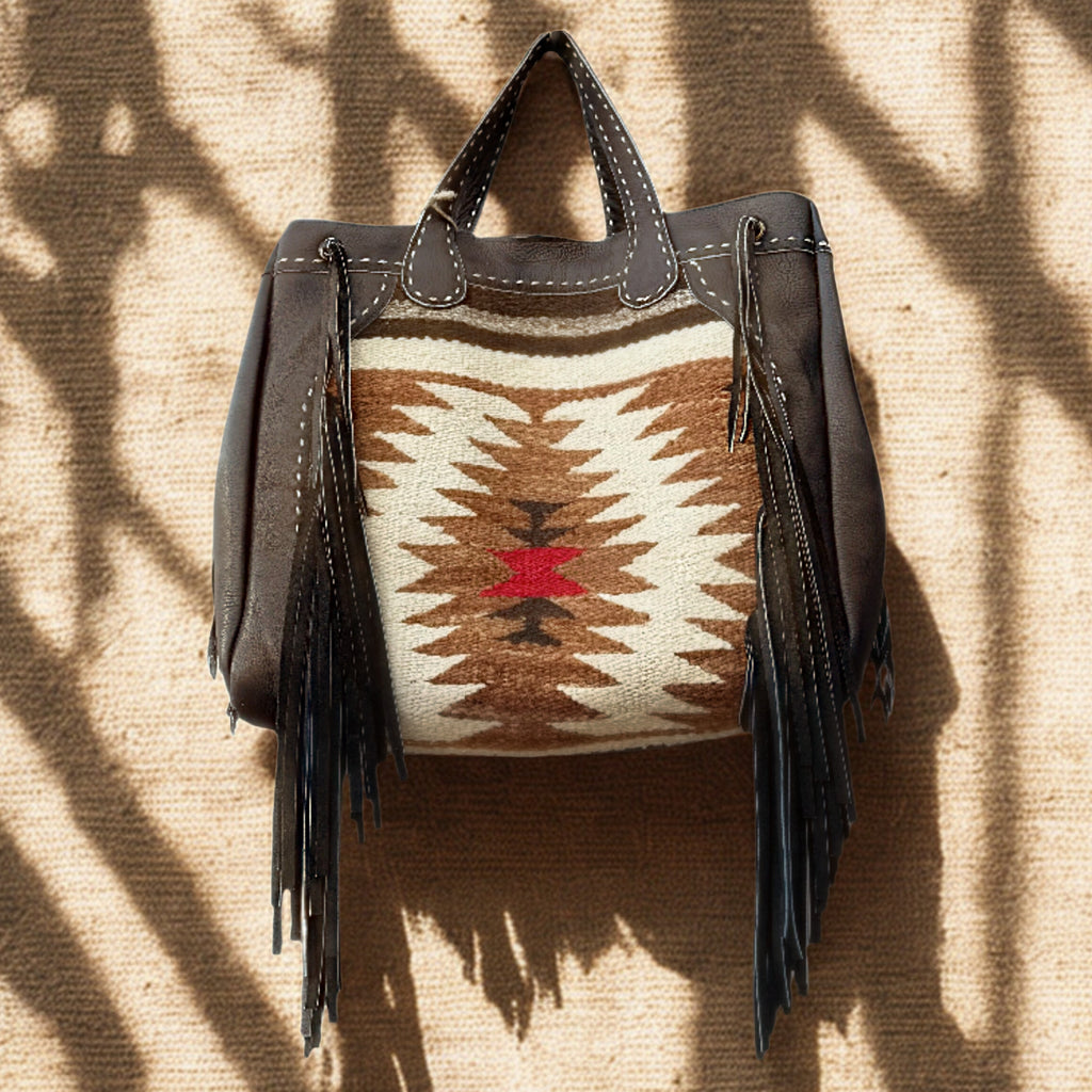 Black leather handbag with fringe details on