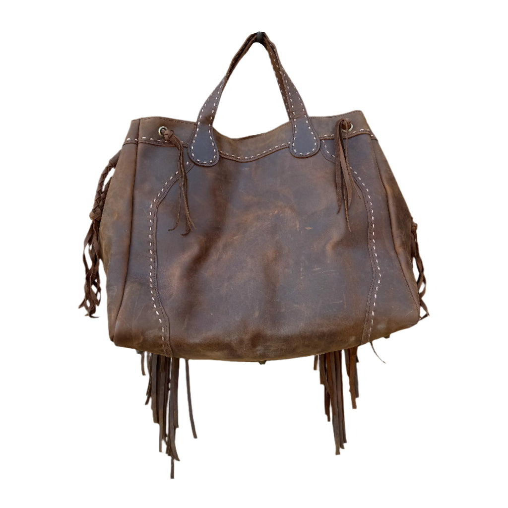 Brown leather handbag with fringe details on a white background