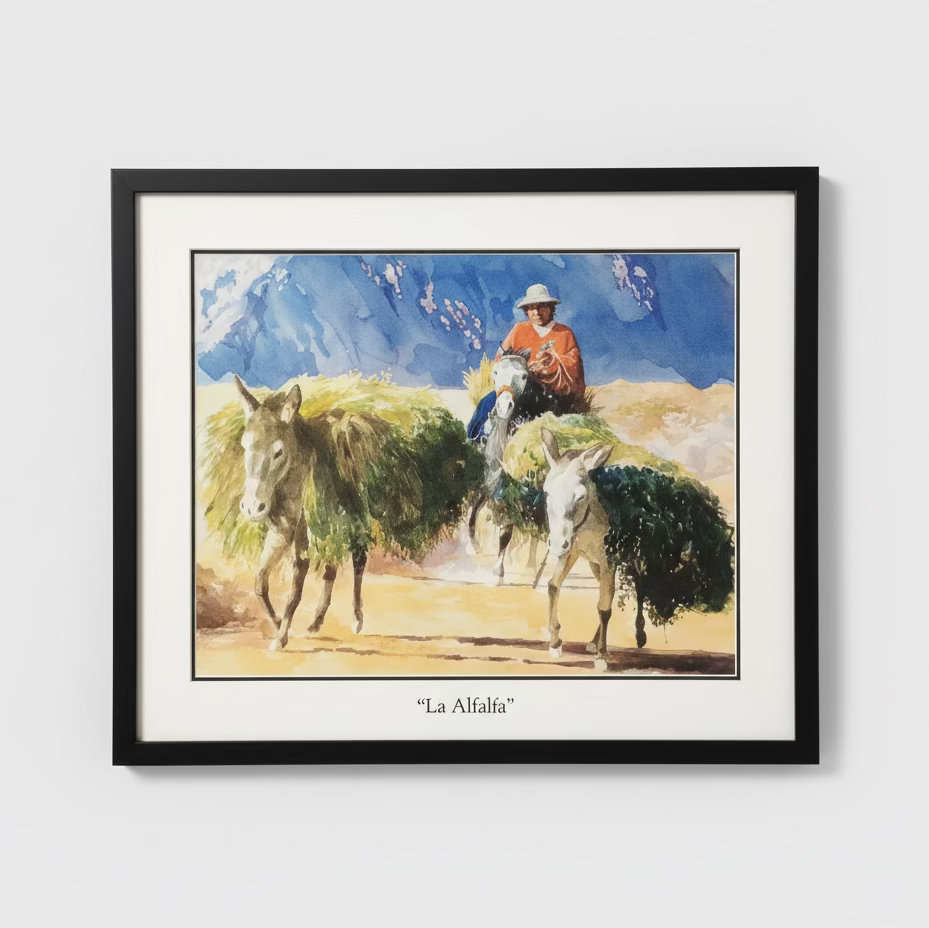 Framed artwork of a man on a donkey with mountains in the background