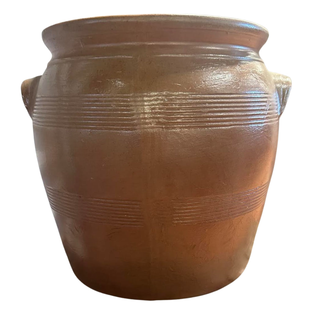 Brown ceramic pot with textured surface on a white background