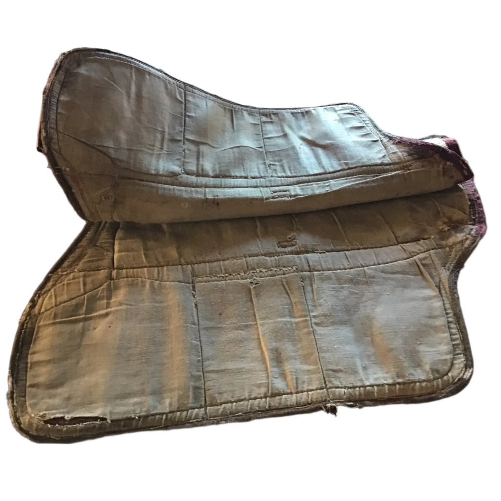 Worn leather saddle bag on a white background