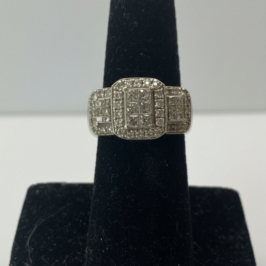 Diamond ring on a black stand with a white background