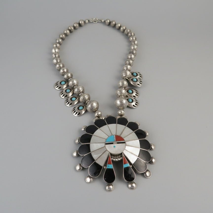 Sterling silver multi-stone Zuni sun face pendant and necklace with blue and turquoise stones.