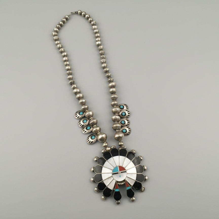 Necklace with a decorative pendant on a gray background